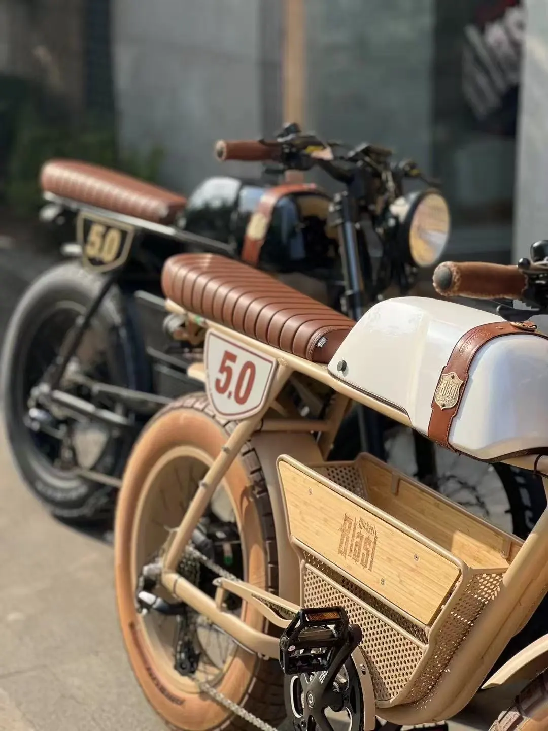 Two Outsider 5.0s side by side, tank and badge detail