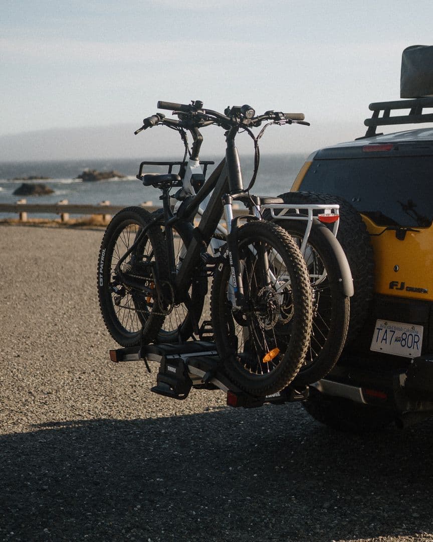 Two Surface 604 eBikes on a hitch rack at the coast